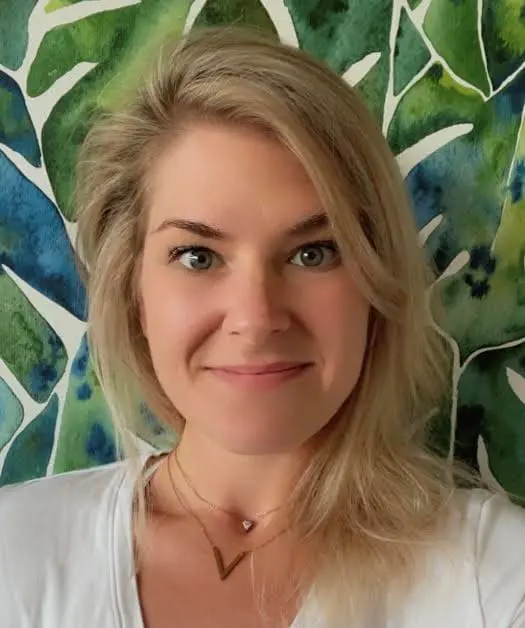 A woman with blonde hair and green eyes.