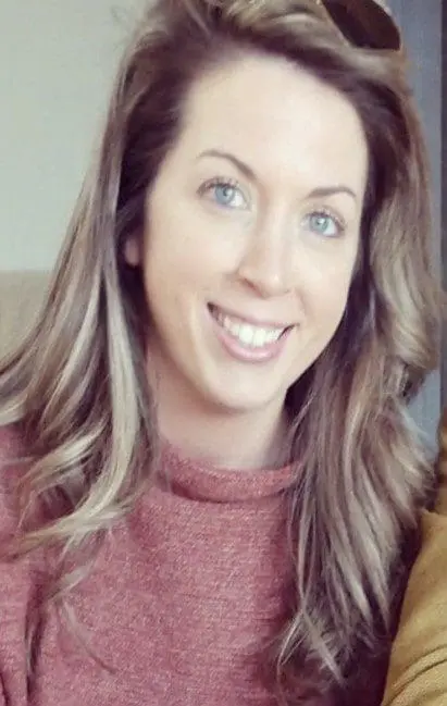 A woman with long hair and blue eyes.