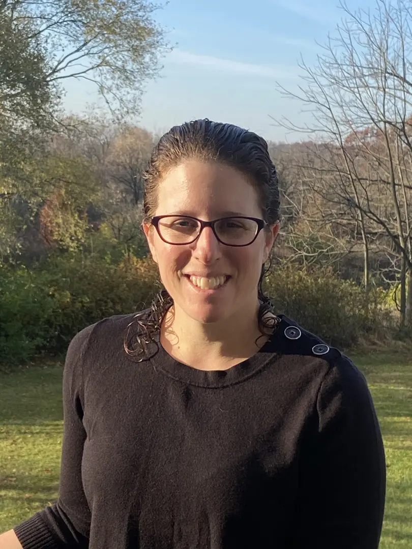 Woman wearing glasses outdoors.