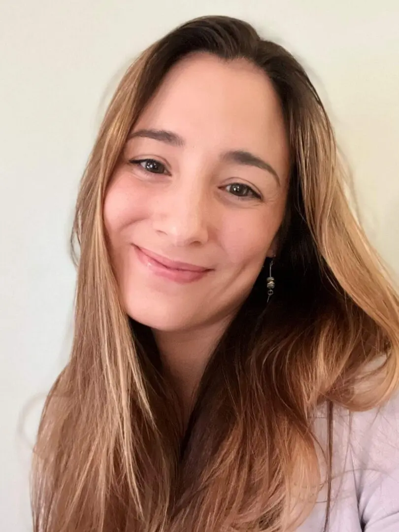 Smiling woman with long brown hair.