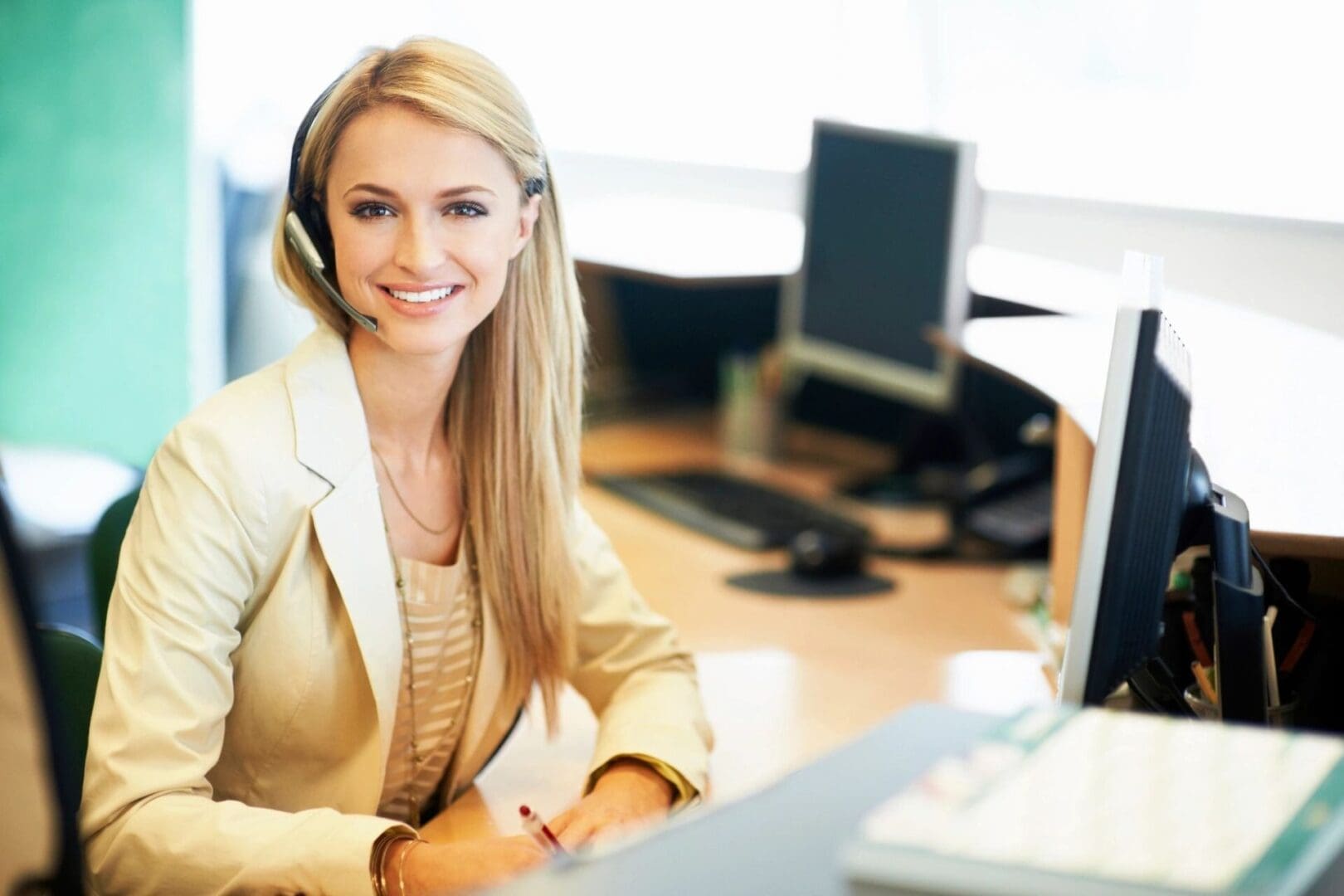 A woman sitting at her desk in front of a computer.